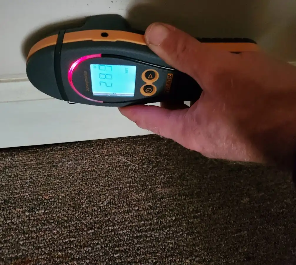 Moisture detection at baseboard during Storm Damage Restoration in Enfield